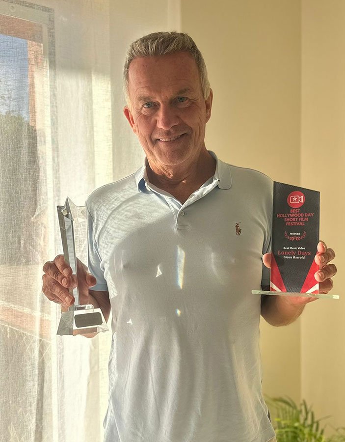 Glenn with awards for Lonely Days & Crazy World
